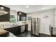 Modern kitchen with stainless steel refrigerator and dark wood cabinets at 1617 Columbia Cir, Decatur, GA 30032