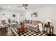 Bright living room with hardwood floors, a ceiling fan, and a connecting dining area at 1617 Columbia Cir, Decatur, GA 30032