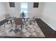 Modern dining area with a glass table, stylish rug, and ample natural light at 1617 Columbia Drive, Decatur, GA 30030