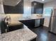 Modern kitchen featuring stainless steel appliances, granite countertops, and sleek black cabinetry at 1617 Columbia Drive, Decatur, GA 30030