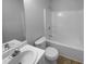 Bright bathroom showcases a white vanity, toilet, and shower/tub combination at 230 Myrtle Grove Ln, Covington, GA 30014