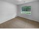 Cozy bedroom features a neutral color scheme and a window with natural light at 230 Myrtle Grove Ln, Covington, GA 30014