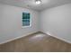 Small, simple bedroom features a neutral color scheme and a window with natural light at 230 Myrtle Grove Ln, Covington, GA 30014