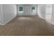 Expansive living room featuring ample carpeted area perfect for various activities and relaxation at 230 Myrtle Grove Ln, Covington, GA 30014