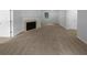 Spacious living room with plush carpeting, a cozy fireplace, and ample room for entertaining at 230 Myrtle Grove Ln, Covington, GA 30014