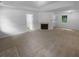 Open-concept living area boasts natural light, neutral carpet and fireplace for an inviting atmosphere at 230 Myrtle Grove Ln, Covington, GA 30014