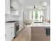 Modern kitchen with white cabinetry, stainless appliances, and hardwood floors at 2424 Memorial Drive Se Dr # 3, Atlanta, GA 30317