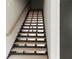 A modern staircase with wood treads and black metal railings is displayed at 2424 Memorial Drive Se Dr # 3, Atlanta, GA 30317