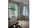Dining area with modern wood table set with view of the greenery outside the large window at 2424 Memorial Drive Se Dr # 7, Atlanta, GA 30317