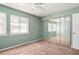 Cozy bedroom featuring a ceiling fan, natural light, and mirrored closet doors, maximizing space at 4266 Roswell Ne Rd # H4, Atlanta, GA 30342
