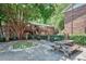 A well-manicured common area features a picnic table, chairs, and a lush green tree providing shade at 4266 Roswell Ne Rd # H4, Atlanta, GA 30342