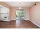 Open concept dining area with wood-look flooring next to the kitchen, and slider to balcony with natural light at 4266 Roswell Ne Rd # H4, Atlanta, GA 30342