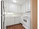 Efficient kitchen with white cabinetry, appliances, and ample lighting, designed for functionality and style at 4266 Roswell Ne Rd # H4, Atlanta, GA 30342