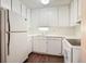 Well-lit kitchen featuring white cabinets, appliances, and countertops, maximizing space and functionality at 4266 Roswell Ne Rd # H4, Atlanta, GA 30342