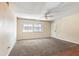 Spacious living room features neutral walls, carpeting, a ceiling fan, and large windows for natural light at 4266 Roswell Ne Rd # H4, Atlanta, GA 30342