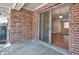 Private patio with brick wall, sliding door to living room, and view of foliage at 4266 Roswell Ne Rd # H4, Atlanta, GA 30342