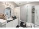 Beautiful bathroom featuring mosaic tile accents in the shower and a modern, round mirror at 1029 Piedmont Ne Ave # 202, Atlanta, GA 30309