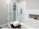 Sleek bathroom with a glass-enclosed shower, soaking tub, and stylish black and white accents at 1029 Piedmont Ne Ave # 202, Atlanta, GA 30309