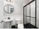Bathroom featuring a pedestal sink, toilet and glass shower with a black frame at 1029 Piedmont Ne Ave # 202, Atlanta, GA 30309