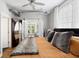 Comfortable bedroom featuring hardwood floors, a ceiling fan and doors to a private balcony at 1029 Piedmont Ne Ave # 202, Atlanta, GA 30309