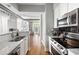 Modern kitchen boasts stainless steel appliances, granite counters, and seamless flow to the naturally lit living space at 1029 Piedmont Ne Ave # 202, Atlanta, GA 30309