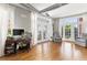 Sunlit living room with rich hardwood floors, access to the balcony, and neutral decor at 1029 Piedmont Ne Ave # 202, Atlanta, GA 30309