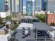 View of a rooftop deck with a table, chairs and outdoor seating with city views at 1029 Piedmont Ne Ave # 202, Atlanta, GA 30309