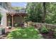 Lovely backyard featuring a wooden deck, a manicured lawn, a patio area, and charming picket fence at 126 Woodbury Ln, Canton, GA 30114
