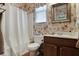 Bathroom featuring patterned wallpaper, a framed mirror, and a shower with a curtain at 126 Woodbury Ln, Canton, GA 30114