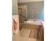 Bathroom featuring a soaking tub, glass enclosed shower and decorative accents at 126 Woodbury Ln, Canton, GA 30114