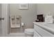 Clean bathroom with a gray color scheme, white vanity, and a framed picture at 126 Woodbury Ln, Canton, GA 30114