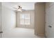 Bright and airy bedroom features a ceiling fan, closet, and large window with natural light at 126 Woodbury Ln, Canton, GA 30114