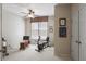Well-lit exercise room with a stationary bike, computer and carpeted floor at 126 Woodbury Ln, Canton, GA 30114