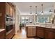 Open kitchen with stainless steel appliances, a sink with modern faucet, and hardwood floors at 126 Woodbury Ln, Canton, GA 30114