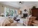 Cozy living room with large windows, fireplace, and built-in bookshelves at 126 Woodbury Ln, Canton, GA 30114