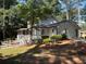 Backyard featuring a screened-in porch, fencing, mature trees, and a blend of open lawn and natural wooded areas at 1789 Springhouse Ct, Lawrenceville, GA 30043