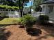 Backyard view showing a lush green bush, wooden deck, and white lattice gazebo at 1789 Springhouse Ct, Lawrenceville, GA 30043