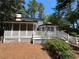 Backyard features a screened porch, deck, and lush landscaping, perfect for outdoor entertaining and relaxation at 1789 Springhouse Ct, Lawrenceville, GA 30043