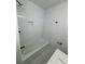 Bathroom featuring a tiled shower and tub with modern fixtures at 1789 Springhouse Ct, Lawrenceville, GA 30043