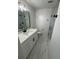 This modern bathroom has white marble floors, quartz countertop and black hardware at 1789 Springhouse Ct, Lawrenceville, GA 30043