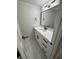Modern powder room with white marble floors, quartz countertop and black hardware at 1789 Springhouse Ct, Lawrenceville, GA 30043