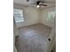 Bright bedroom featuring neutral carpeting, a ceiling fan, and two windows providing ample natural light at 1789 Springhouse Ct, Lawrenceville, GA 30043