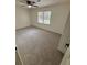 Cozy bedroom with neutral carpeting, ceiling fan, and closet featuring two bright, sunlit windows at 1789 Springhouse Ct, Lawrenceville, GA 30043