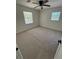 Bedroom showcasing neutral carpeting, a ceiling fan, and two windows providing ample natural light at 1789 Springhouse Ct, Lawrenceville, GA 30043