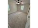 Neutral bedroom with carpet, a ceiling fan, and a sliding barn door feature at 1789 Springhouse Ct, Lawrenceville, GA 30043
