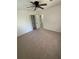 Bedroom featuring neutral carpeting, a ceiling fan, and a door to the hall with closet and a window at 1789 Springhouse Ct, Lawrenceville, GA 30043