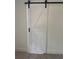 Modern white barn door with black hardware adding a stylistic touch to the home's interior at 1789 Springhouse Ct, Lawrenceville, GA 30043
