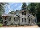 Charming two-story home featuring a classic white facade, black shutters, and a well-manicured front yard at 1789 Springhouse Ct, Lawrenceville, GA 30043