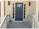 Inviting entryway with a blue front door, white trim, and stylish sconces, creating a welcoming curb appeal at 1789 Springhouse Ct, Lawrenceville, GA 30043
