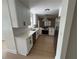 Well-lit kitchen with stainless steel appliances, white cabinets, and light wood flooring at 1789 Springhouse Ct, Lawrenceville, GA 30043